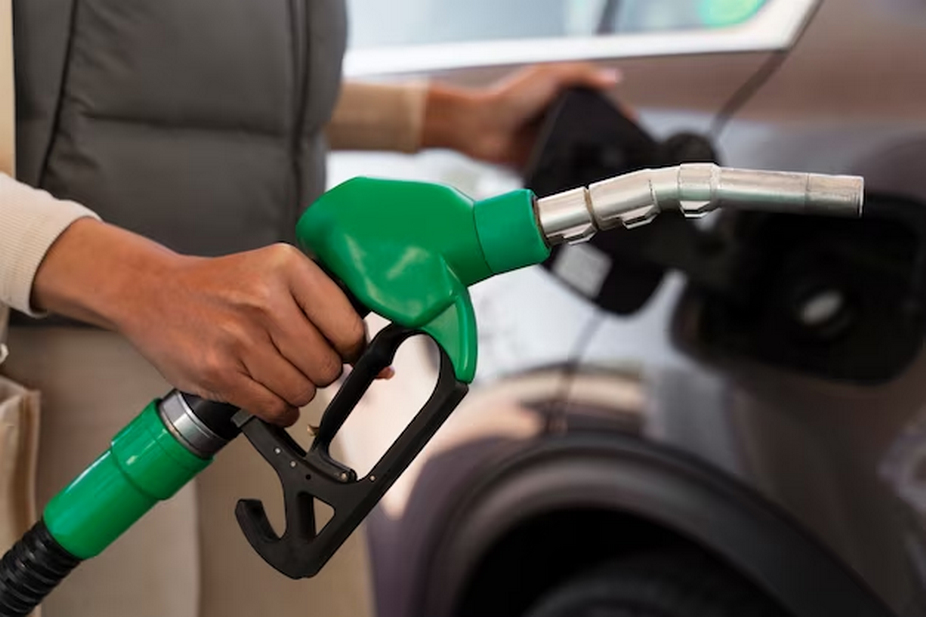 Hand filling up a car with fuel