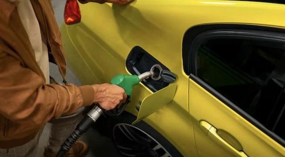 A man fills a car with gasoline