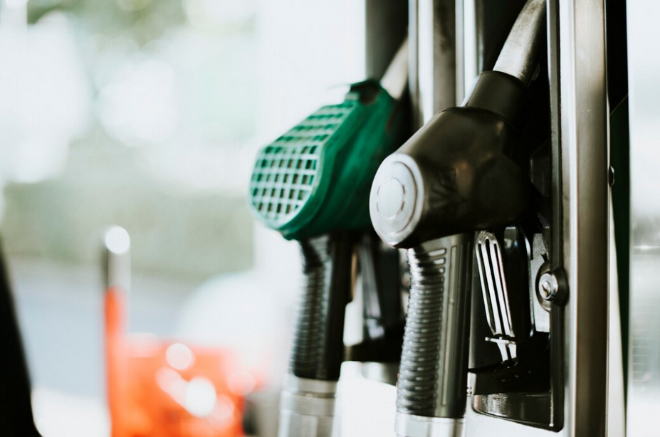 Closeup view of green and black fuel nozzles at a gas station