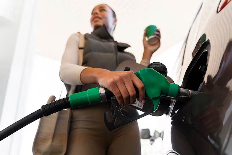 Woman filling up a car at a gas station