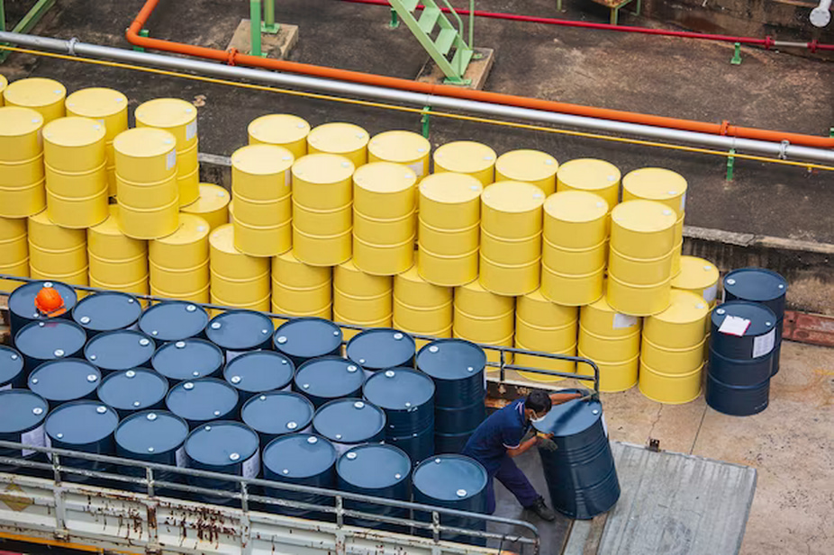 A man stacks barrels of diesel