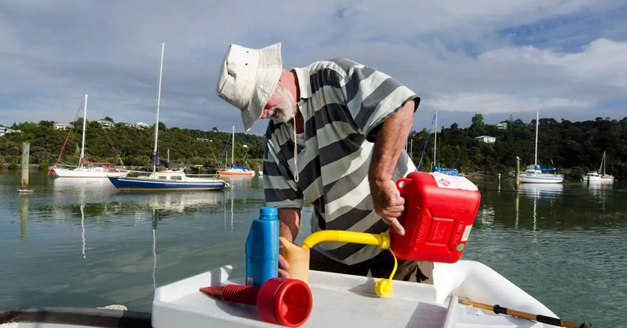 A man fills a boat with gasoline